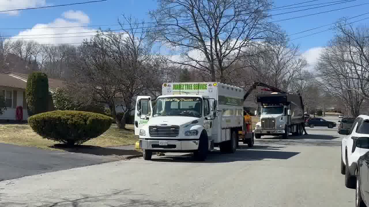 Residential tree services company truck and crew arriving at a home for professional tree removal and tree trimming service