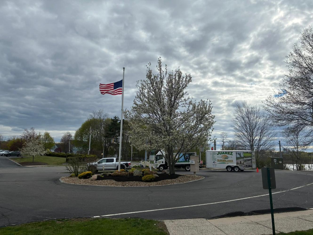Commercial landscape bed maintenance by Juarez Landscaping and Tree Services around a landscaped property entrance